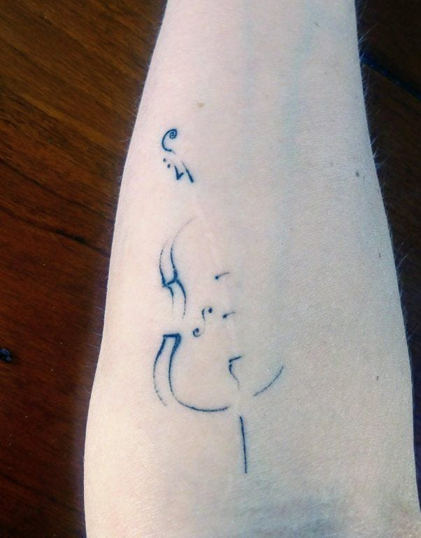 Here is an artistic way to cover up a scar. According to the person with the scar, it is over 30 years old. The blue coloration of the tattoo and its almost translucent nature goes along perfectly with this person’s pale skin. Beautifully done!